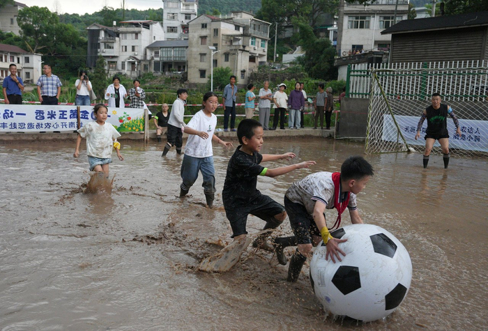 7月9日，绍兴市新昌县城南乡杨家山村开心农场，孩子们正在进行趣味泥地足球比赛。拍友 俞晓委 摄
